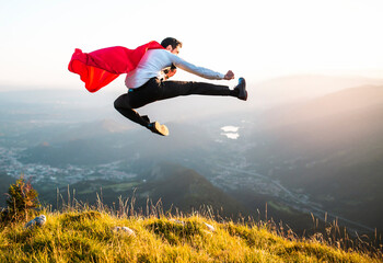 Man with superhero cape kicks kung fu.