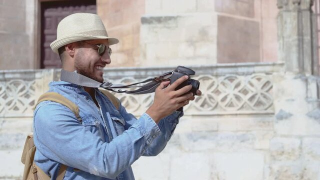 Handsome tourist checking photos in digital camera. High quality 4k footage