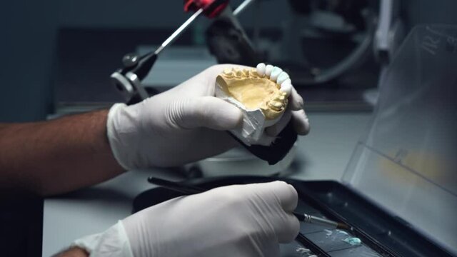 dental technician creates dental prostheses. laboratory. close-up.