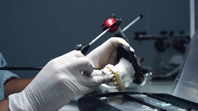 dental technician creates dental prostheses. laboratory. close-up.