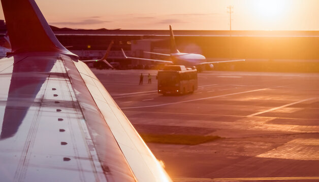Airplane at sunset on the runway.