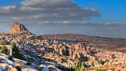 Travel to fairy Cappadocia. Magnificent panoramic view to Uchisar rock-cut Castle and town surrounding area at the sunset, Cappadocia, Nevsehir Province,Turkey