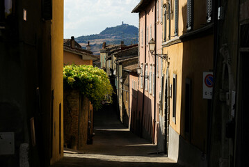 medieval streets of an old town in Italy surrounded by sun rays 