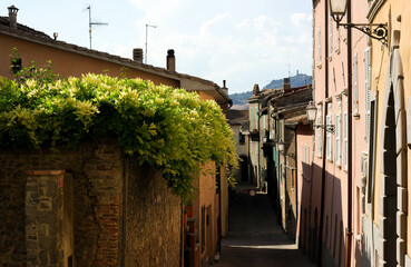 medieval streets of an old town in Italy surrounded by sun rays 