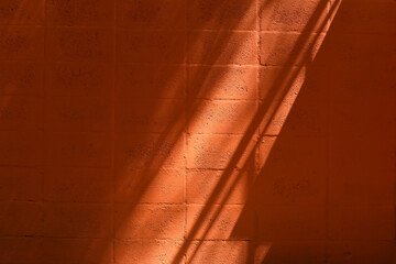 texture, orange brick wall, pattern, with rays of overhead light. Graphic resource