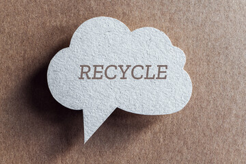 Recycle word written on cardboard speech bubble, copy space