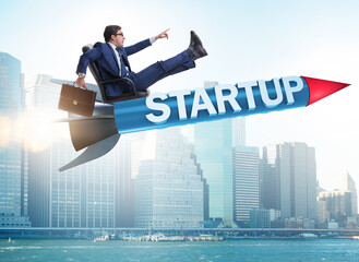 Businessman in start-up concept flying on rocket