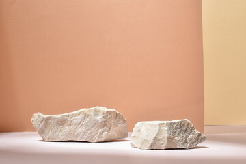 Stone podium for the presentation of goods and cosmetics on a beige background. - obrazy, fototapety, plakaty