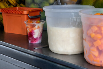 Preparation of a traditional sweet water ice with fruits called cholado in the city of Cali in Colombia