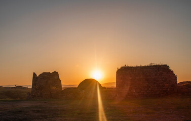 Bright orange sunset above the old fortress. Georgia.
