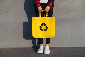 woman holding shopping bag with recycling symbol, Ecological recycling concept, reuse, Woman in...