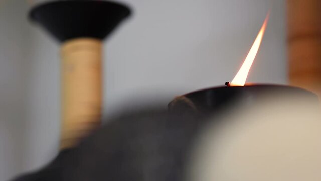 Starting from candle flame out of focus, gradually shifting focus through decorative balls on the foreground projecting calm and tranquility.