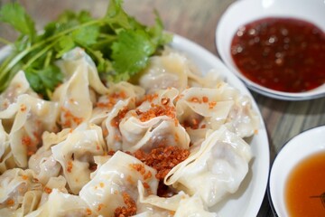 Close up fresh boiled dumplings . Chinese food on rustic old vintage wooden background. Asian dumplings in bowl, chopsticks, Chinese dumplings for dinner.