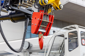 New wheel crane hook. Fragment of the boom of a new mobile crane. Parts of construction equipment