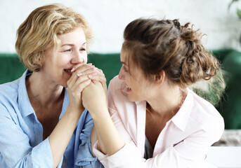 lifestyle, family and people concept: Happy young woman and her mother at home, happy family