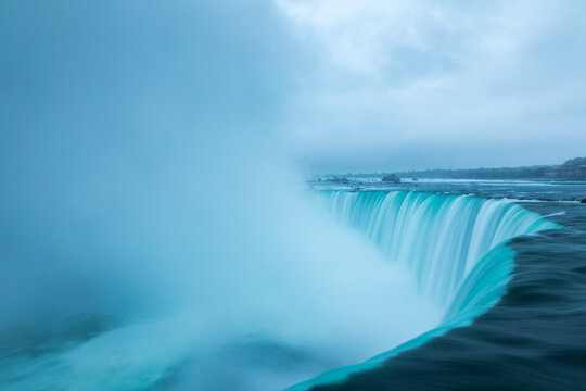 Naklejki A stormy morning over the iconic Niagara Falls located on the boarder of the United States and Canada.