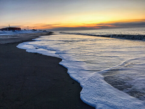 Foam reflections. Arctic Ocean sunset. 