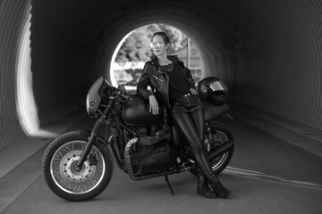 young woman on a black motorcycle