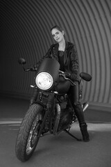 Fototapeta na wymiar young woman on a black motorcycle