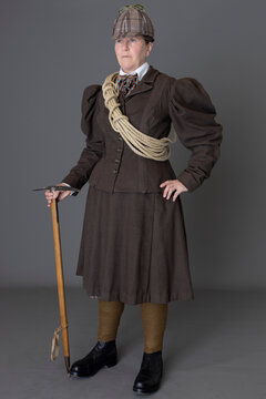 A Victorian Woman Wearing A Mountain Climbing Ensemble Including A Pick, Rope, And Hobnail Boots