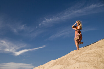 young woman on sandy mountain
