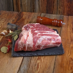 Raw pork ribs are laid out on a cutting board.Spices for cooking meat dishes close-up.Selective Focus.