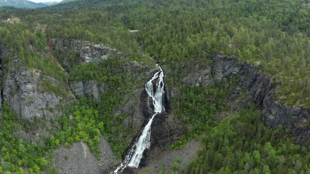 Aerial view around the Gloppefossen falls, in Norway - circling, tilt, drone shot