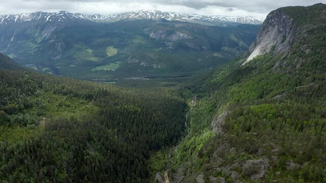 Aerial view over a canyon and valley, in Setesdal, south Norway - tilt, drone shot