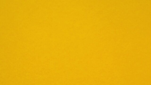 Looped stop motion animation with orange and pink background. A paper ball spreads making a blank sheet for text