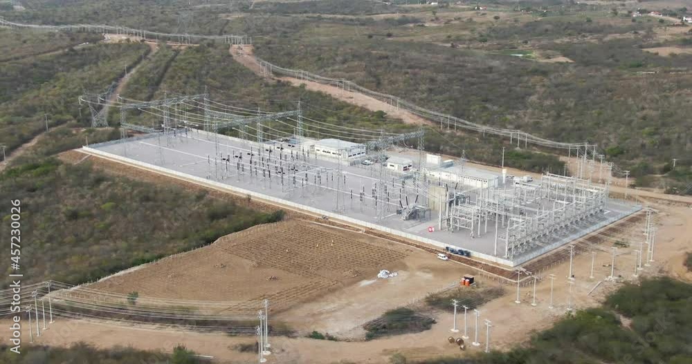 Poster electrical substation drone shot. hydroelectric power station with grid of high voltage power lines 