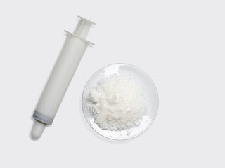Fototapeta na wymiar White syringe and sodium chloride, medical equipment on white laboratory table.