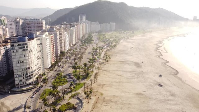 The millionaire's beach in Sao Vincente Brazil. The endless beach is very wide. The footage shows the shore and beach in a beautiful morning mist with the sun rising creating a magic color.
