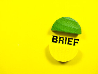Business concept.Text BRIEF with colored wooden block on a yellow background.