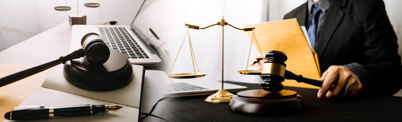 Business and lawyers discussing contract papers with brass scale on desk in office. Law, legal services, advice, justice and law concept