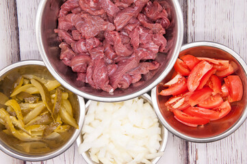 Sliced beef or pork meat with fresh vegetables top view
