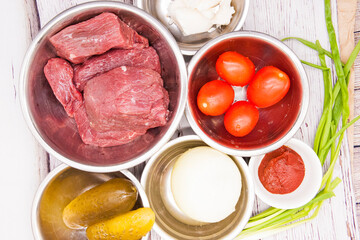 Sliced beef or pork meat with fresh vegetables top view