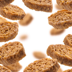 Bread croutons levitate on a white background