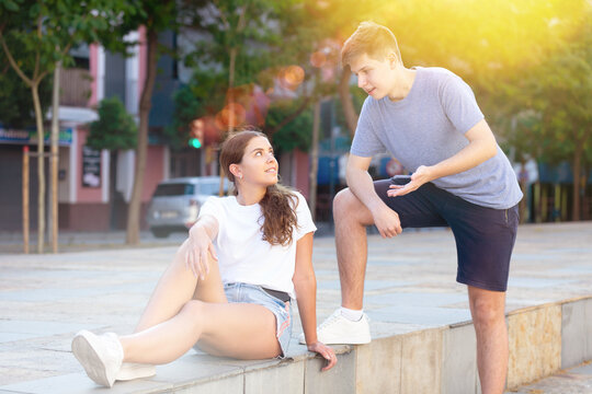 Portrait Of Two Teenage Friends Chatting Outdoors In Town