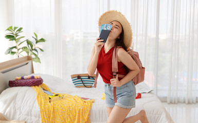 Asian happy female traveler with big hat and backpack smile and laugh with excited wow face holding...