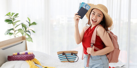Asian happy female traveler with big hat and backpack smile and laugh with excited wow face holding...