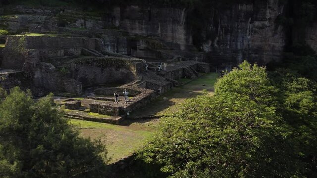 A troop of Mexican soldiers patrolling the old Aztec ruins located in the hillside above Malinalco, Mexico.  
Pyramid in the jungle was a retreat for elite aztec warriors.  Cinematic and stunning.