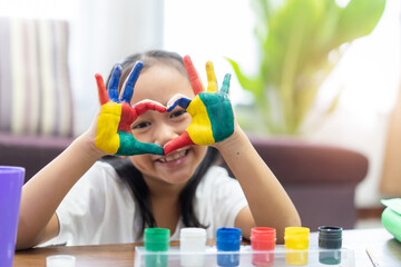 Happy cute asian little girl with colorful painted on hands and make a heart shape, Study From Home...