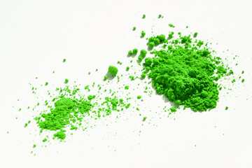Close up of a large and a small portion of green pigment isolated on white. The pigment can be used as a base for makeup or mixed with linseed oil to make oil paint