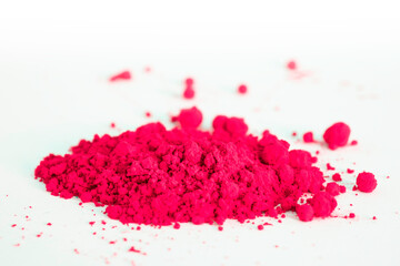 Close up of a portion of red pigment isolated on white in side view. The pigment will be mixed with linseed oil to make oil paint. Narrow depth of field