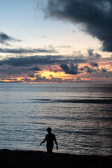 Fototapeta premium Silhouette photo of a man walking on the beach