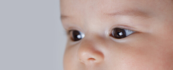 Close up view of beautiful baby eyes. Eye health care. Macro photo of brown eyes of a child.