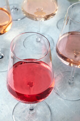 Rose wine of various shades at a tasting in a winery. Winetasting event. Elegant wineglasses