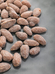 almonds with sweet sprinkles on a plate on a white background