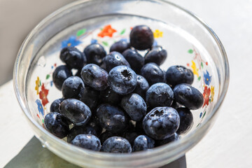 Blueberries in the Glass Bowl . Healthy berries for breakfast 