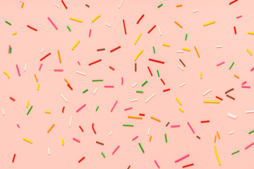 trendy pattern of colorful sprinkles for background of design banner, poster, flyer, card, postcard, cover, brochure over pink